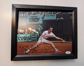 Autographed John McEnroe 8x10 inch framed photo with certificate of authenticity from JSA