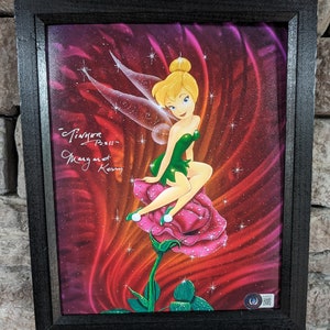 May include: A framed print of Tinker Bell sitting on a pink rose with a sparkling background. The print is signed "Tinker Bell" and "Margaret Kerry".