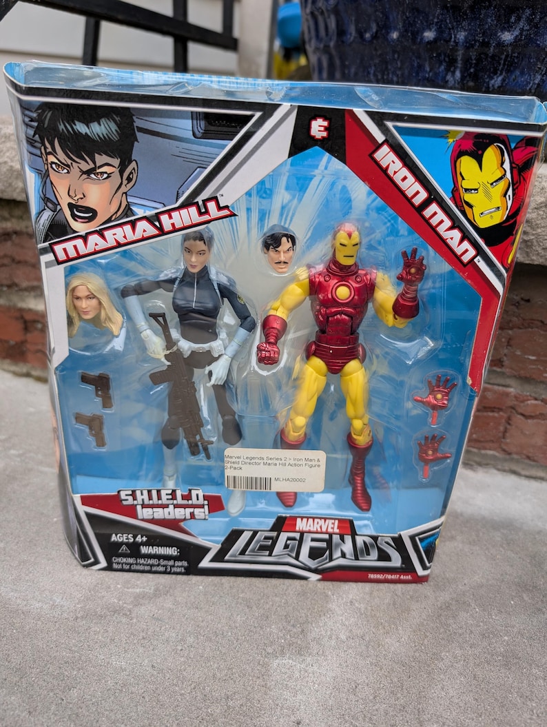 May include: A Marvel Legends action figure set featuring Iron Man and Maria Hill. The figures are posed in action stances and come with accessories. The packaging features the Marvel Legends logo and the characters' names.