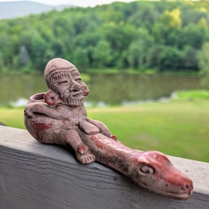 Vintage hand made Mexican folk art clay pipe featuring a man riding a snake