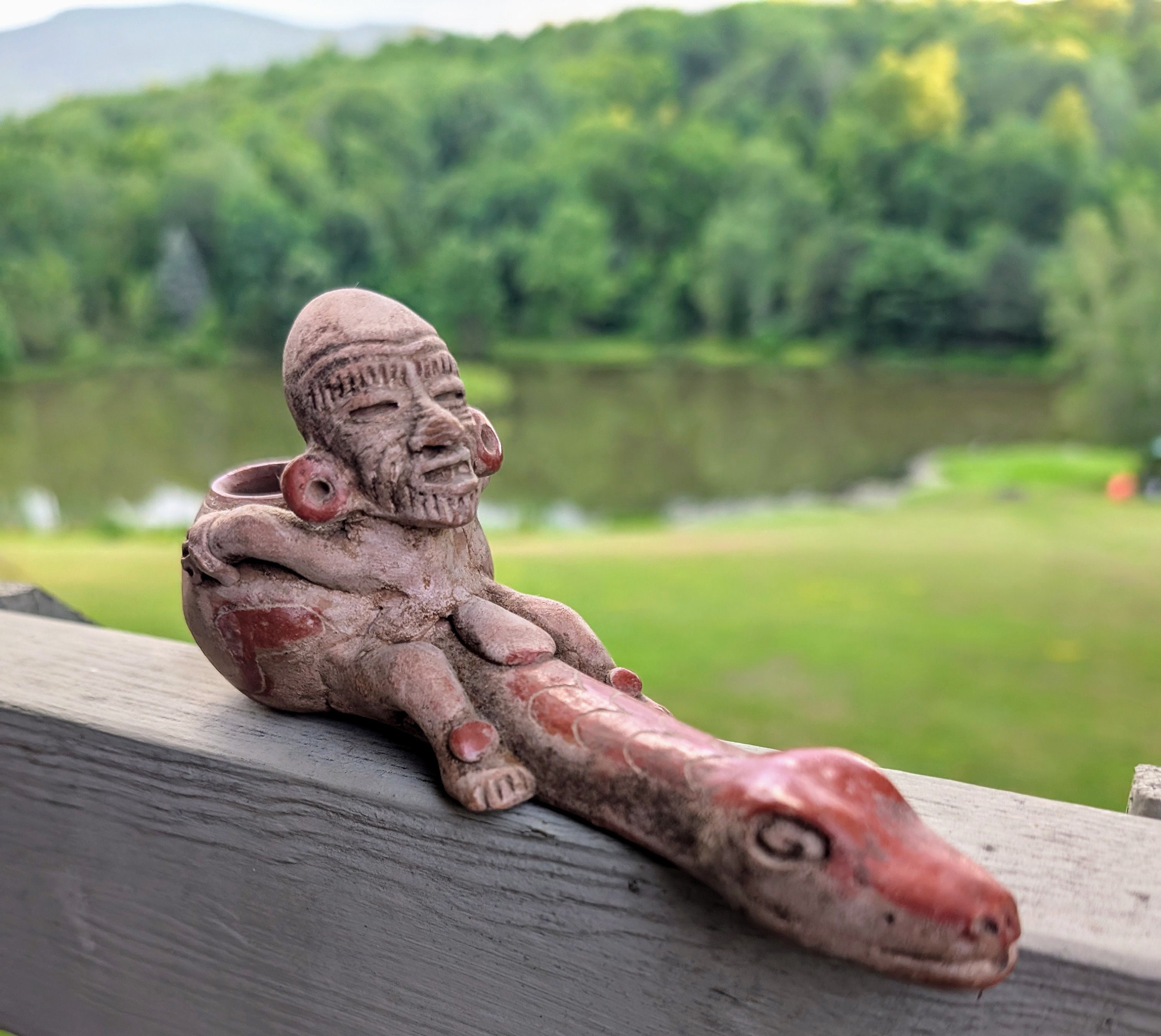 Vintage hand made Mexican folk art clay pipe featuring a man riding a snake