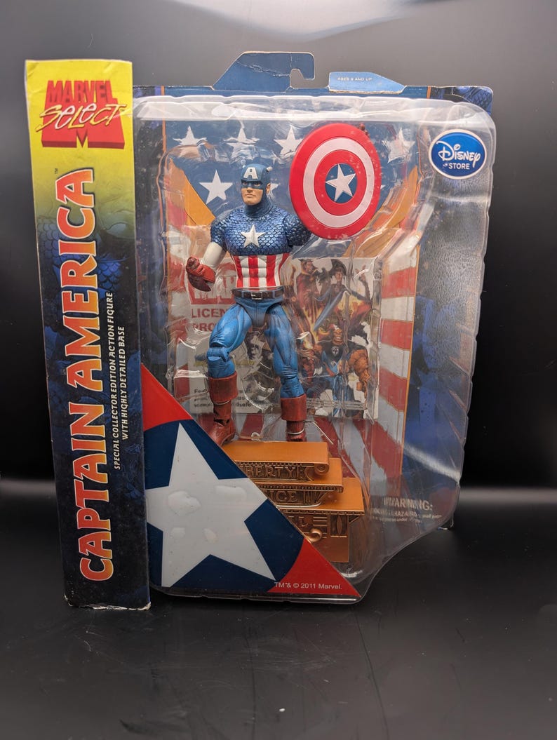 May include: A Captain America action figure in a clear plastic package. The figure is in a classic costume, holding a shield. The packaging includes the Marvel Select and Disney Store logos, with text that reads "Captain America".