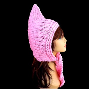 a pink knitted pixie hood hat on a mannequin head