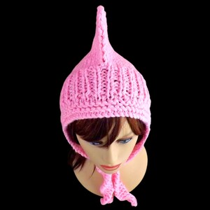 a pink knitted pixie hood hat on a mannequin head