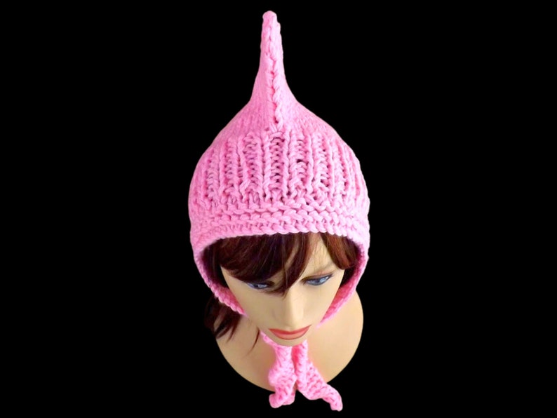 a pink knitted pixie hood hat on a mannequin head