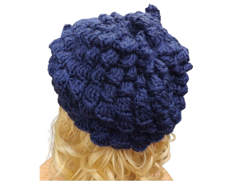 a mannequin head wearing a blue crocheted hat