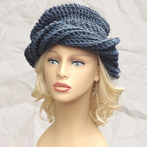 Frontal view of a mannequin head sporting the unique Samantha slouchy Crochet Mobius hat in navy blue, with a focus on the intricate twisted brim design