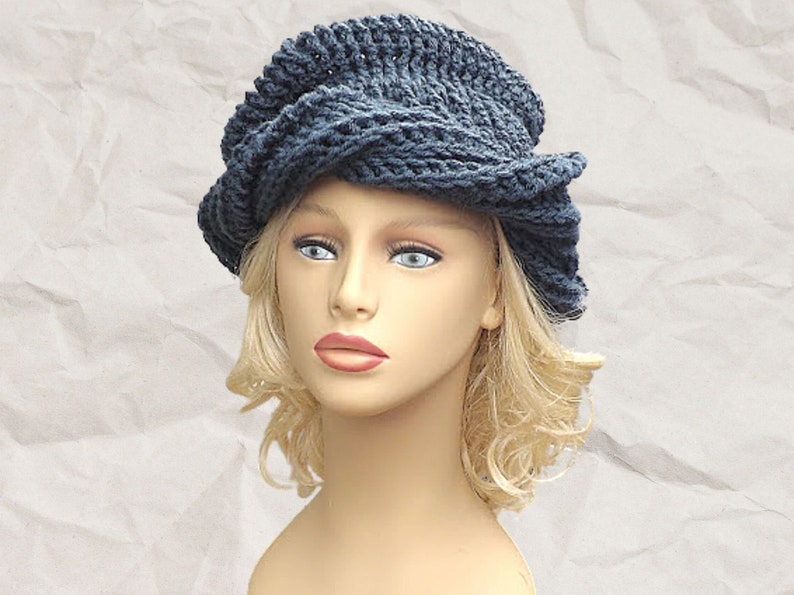 Frontal view of a mannequin head sporting the unique Samantha slouchy Crochet Mobius hat in navy blue, with a focus on the intricate twisted brim design