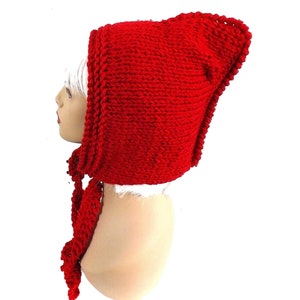 a red knitted hat on a mannequin head