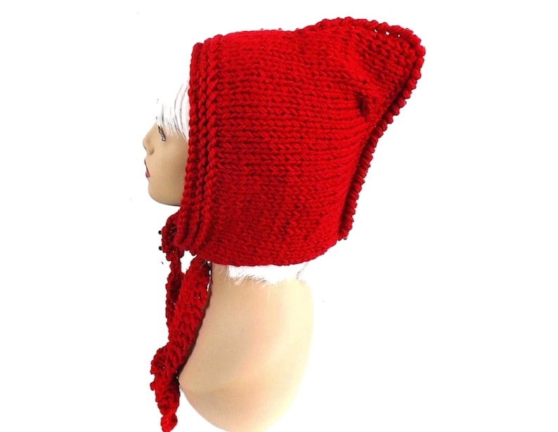 a red knitted hat on a mannequin head