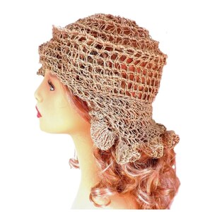 a mannequin head wearing a natural hemp twine hat with a diagonal ruffle