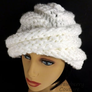 "Elegant white Ombretta chemo cloche hat on a mannequin with a textured design, showcasing a stylish fit for comfort and warmth."