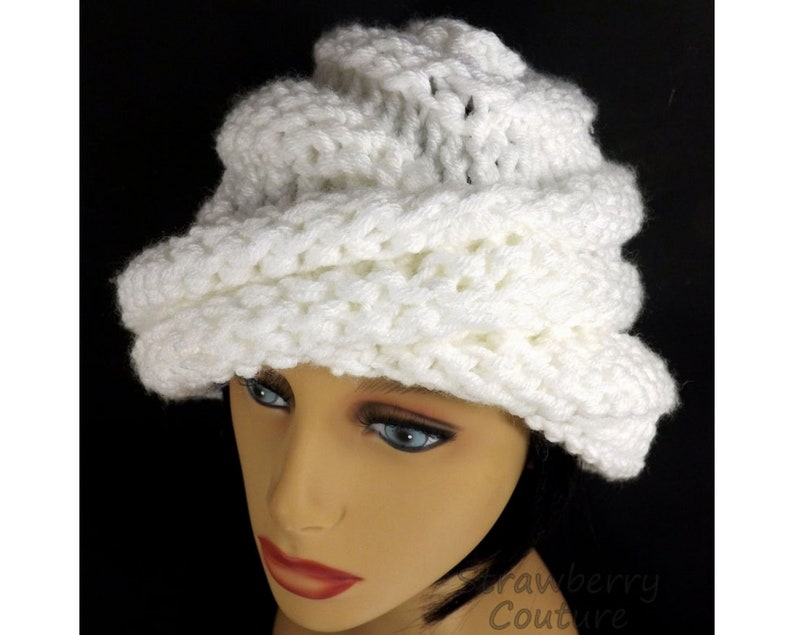 "Elegant white Ombretta chemo cloche hat on a mannequin with a textured design, showcasing a stylish fit for comfort and warmth."