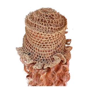 a mannequin head wearing a natural hemp twine hat with a diagonal ruffle