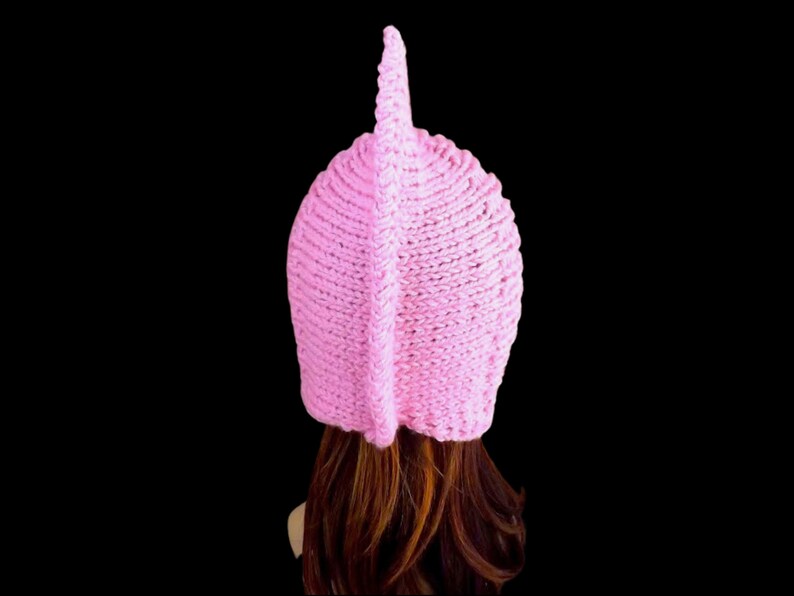 a pink knitted pixie hood hat on a mannequin head