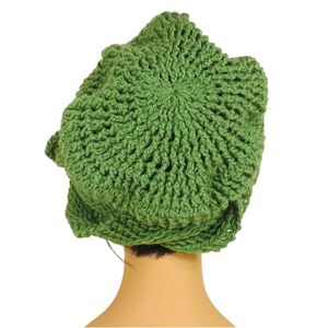 Unique Möbius Crochet Hat Pattern - Samantha Slouchy Beanie with Twist Brim. The green knit slouchy beanie hat with twisted brim modeled on a mannequin head, viewed from a slightly lower angle showing more of the top of the hat.