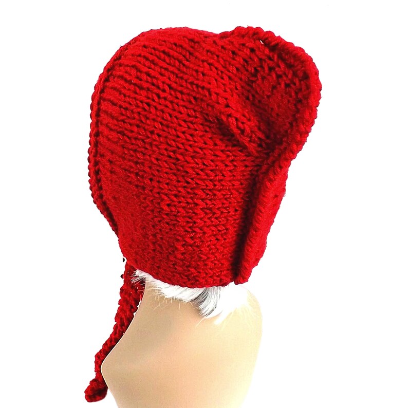 a red knitted hat on a mannequin head