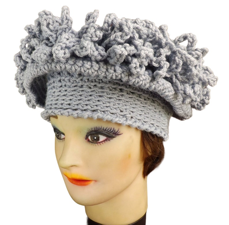 a mannequin head wearing a gray crochet hat