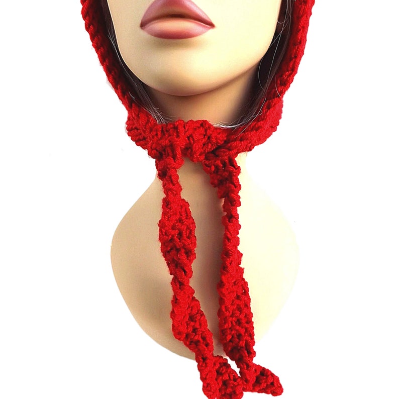 a mannequin wearing a red knitted hat and scarf