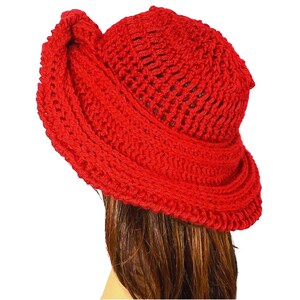 Red Mobius crochet hat presented in a tilted side view, emphasizing the voluminous brim and stylish silhouette