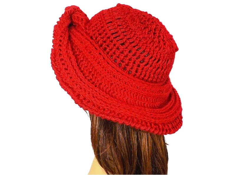 Red Mobius crochet hat presented in a tilted side view, emphasizing the voluminous brim and stylish silhouette