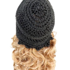 a black crochet hat on top of a blonde wig