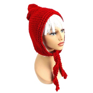 a mannequin head wearing a red knitted hat