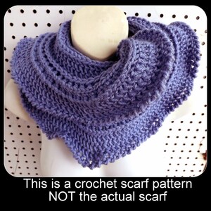 a blue crocheted scarf on a mannequin