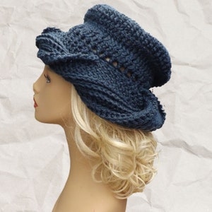 a mannequin head wearing a blue crocheted hat