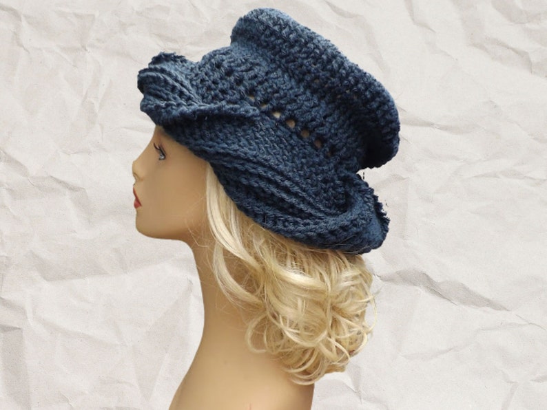 a mannequin head wearing a blue crocheted hat