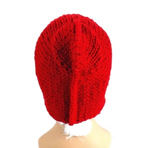 a red knitted hat on a mannequin head