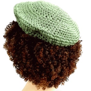 a close up of a wig with a crochet hat on top of it