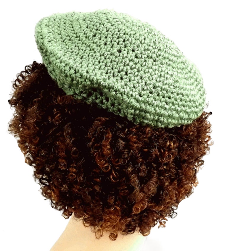 a close up of a wig with a crochet hat on top of it