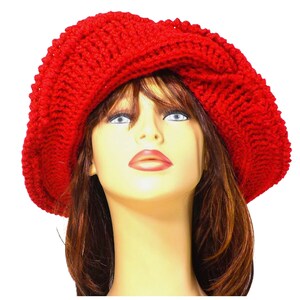 Frontal view of the red Mobius crochet hat with the brim turned up, illustrating the versatility of the hat's styling