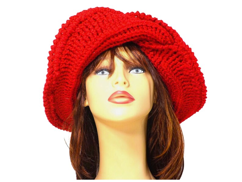 Frontal view of the red Mobius crochet hat with the brim turned up, illustrating the versatility of the hat's styling