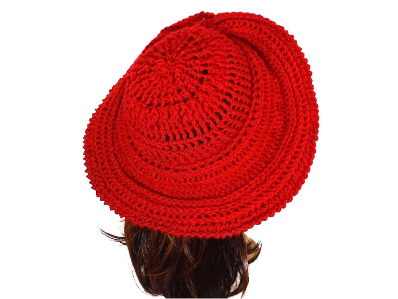 Another angle of the red Mobius crochet hat from the side, accentuating the hat's dimensional brim and elegant twist