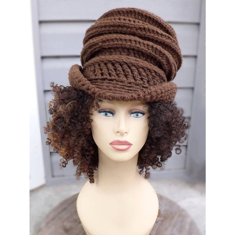 A brown crocheted hat with a swirled, ribbed texture. The hat has an oversized, slouchy fit.