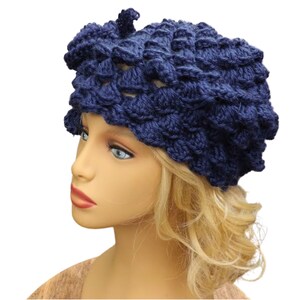 a mannequin head wearing a blue crocheted hat