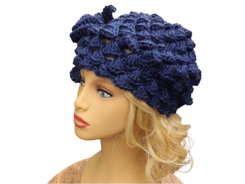 a mannequin head wearing a blue crocheted hat