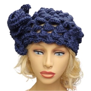 a mannequin head wearing a blue crocheted hat
