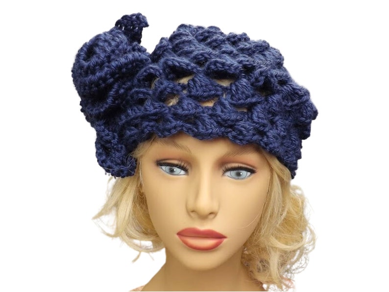 a mannequin head wearing a blue crocheted hat