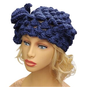 a mannequin head wearing a blue crocheted hat