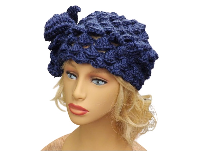 a mannequin head wearing a blue crocheted hat