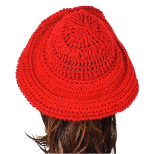 Back view of the red Mobius crochet hat, highlighting the detailed stitch patterns and the distinct Mobius twist at the back