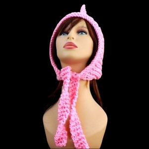 a pink knitted pixie hood hat on a mannequin head