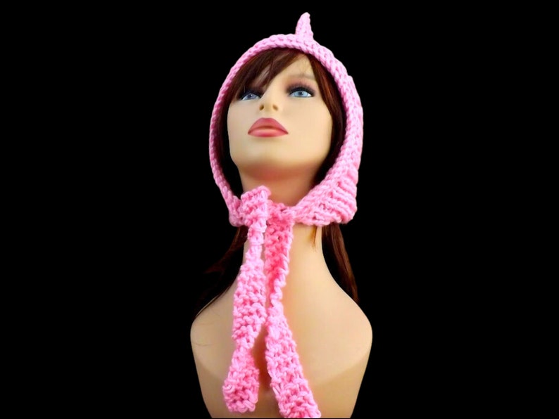 a pink knitted pixie hood hat on a mannequin head