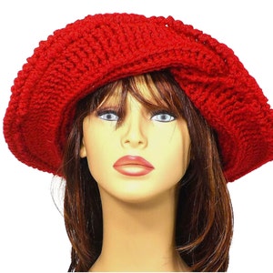 Frontal view of the red Mobius crochet hat with the brim turned up, illustrating the versatility of the hat's styling