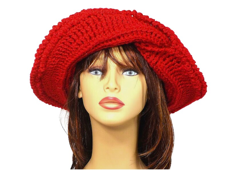 Frontal view of the red Mobius crochet hat with the brim turned up, illustrating the versatility of the hat's styling