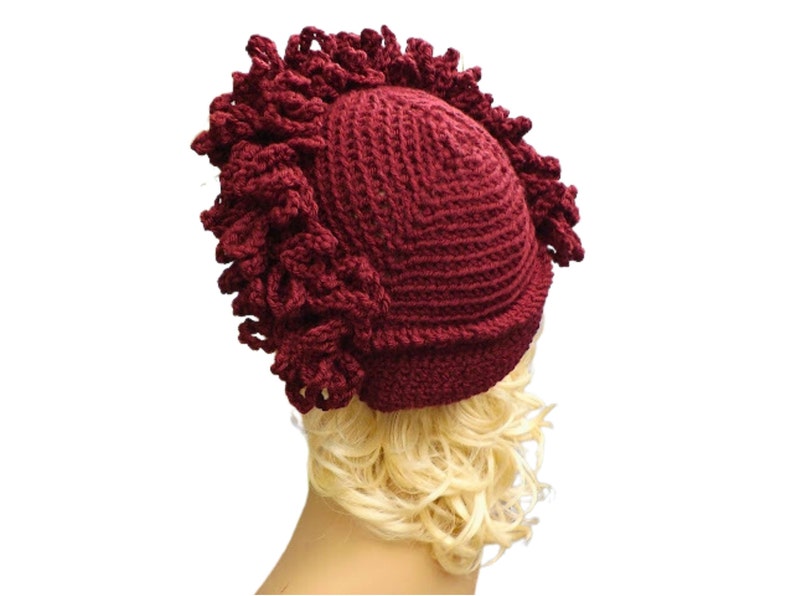 a mannequin head wearing a burgundy crocheted hat