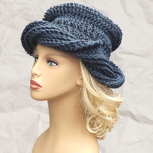 a mannequin head wearing a blue crocheted hat